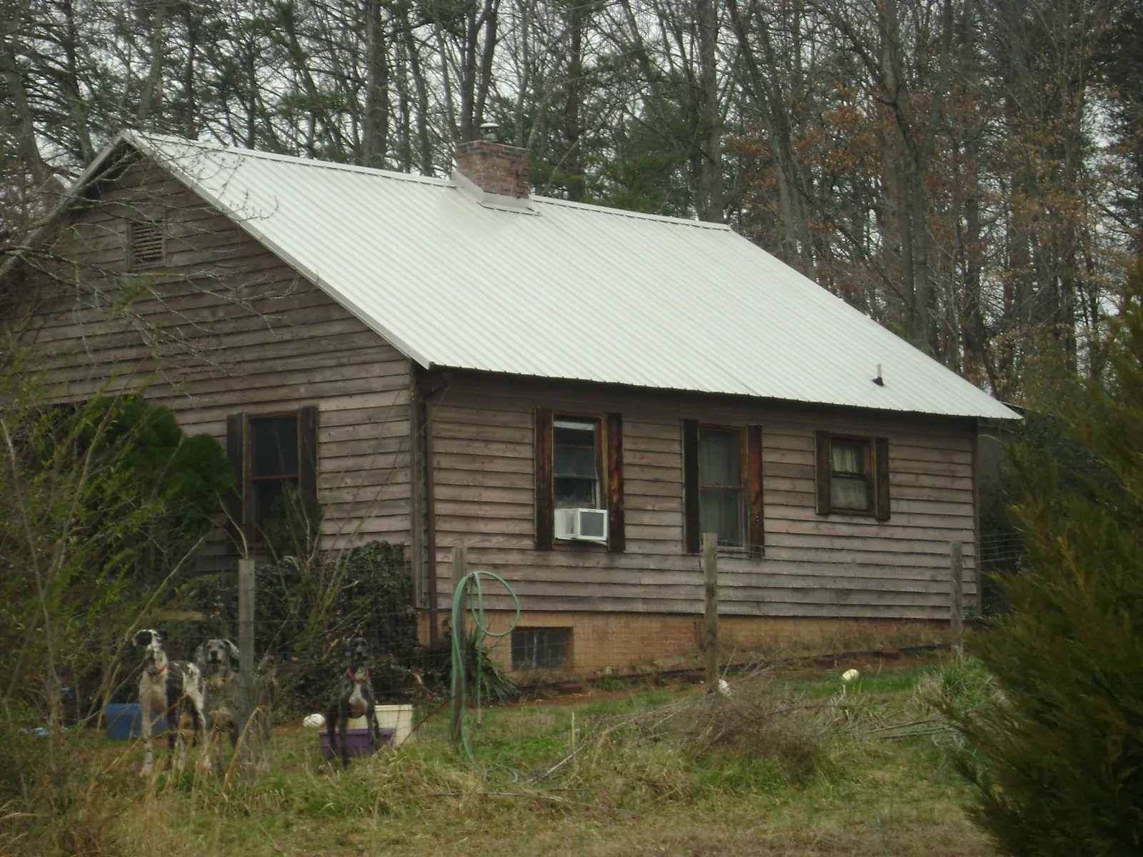 White metal roof on an old wood sided farmhouse, from a Asphalt Shingle Roof Repair job in Faulkner